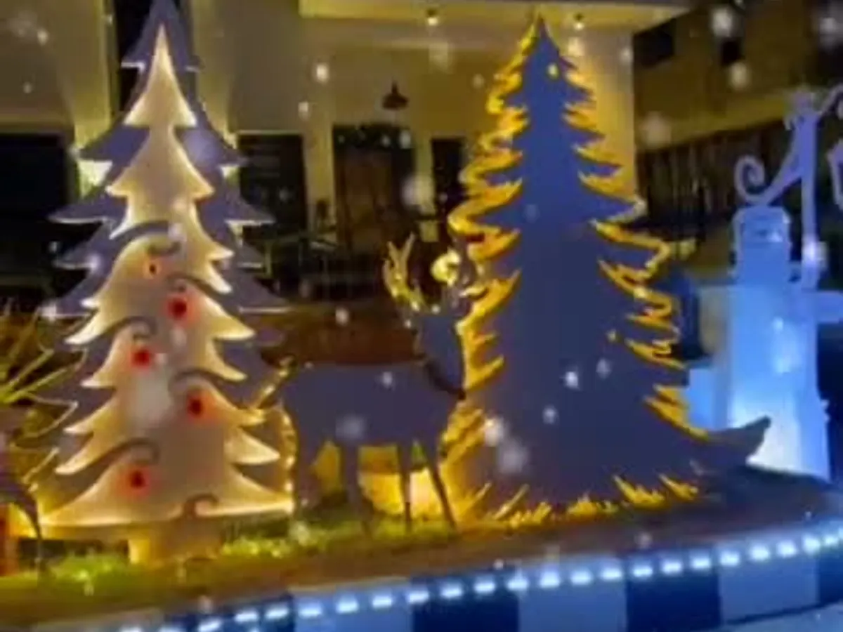 A hotel lobby dressed with a tall lit Christmas tree